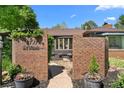 Close up of beautiful brick entryway with potted flowers and address plaque at 2717 S Steele St, Denver, CO 80210
