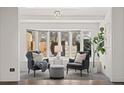 Bright living room featuring a bay window, two armchairs, and stylish decor in a neutral color palette at 2717 S Steele St, Denver, CO 80210