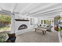 Cozy living room with a fireplace, exposed beams, and a large window for natural light at 2717 S Steele St, Denver, CO 80210