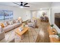 Virtually staged living room featuring hardwood floors and ample natural light at 841 Elmira St, Aurora, CO 80010