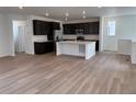 Open-concept floorplan featuring hardwood flooring, a kitchen, and recessed lighting at 7307 Waterleaf Trl, Littleton, CO 80125