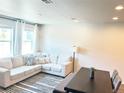 Bright living room featuring a large sectional sofa, neutral colors, and contemporary decor at 19221 E 65Th Ave, Denver, CO 80249