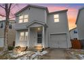 Attractive home with attached garage and covered entry, highlighted by a serene dusk sky backdrop at 11848 W Tufts Pl, Morrison, CO 80465