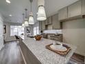 Lovely kitchen with granite counters, modern pendant lighting, and stainless steel sink at 12979 E 103Rd Pl, Commerce City, CO 80022