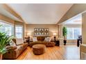 Cozy living room with plush sofas, an ottoman, and large windows offering plenty of natural light at 5473 W Prentice Ct, Littleton, CO 80123