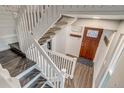 Bright entryway featuring a wooden door, fresh paint, and wood flooring at 2980 S Parker Ct, Aurora, CO 80014