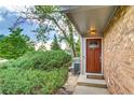 Inviting front entrance with a wooden door and beautiful brick accents at 2980 S Parker Ct, Aurora, CO 80014