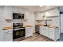 Modern kitchen featuring stainless steel appliances and butcher block countertops at 2980 S Parker Ct, Aurora, CO 80014