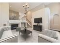 Open living room featuring a fireplace, staircase, and vaulted ceilings at 10311 Belvedere Ln, Lone Tree, CO 80124