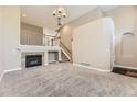 Bright living room with high ceilings, carpet, and a fireplace with a stone surround at 10311 Belvedere Ln, Lone Tree, CO 80124