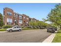 Charming street featuring brick townhomes, manicured landscaping, and tree-lined sidewalks at 10311 Belvedere Ln, Lone Tree, CO 80124