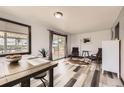 Inviting dining area with natural light, modern furnishings, and wood-look floors at 8361 Mason Cir, Westminster, CO 80031