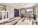 Charming dining room featuring wood-look flooring and white display cabinet at 8361 Mason Cir, Westminster, CO 80031