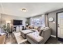 Comfortable living room with plush sectional sofa, TV, and neutral decor at 8361 Mason Cir, Westminster, CO 80031
