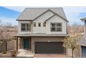 Charming two-story home featuring a two-car garage, a well-manicured yard, and stylish architectural details at 19060 E 54Th Pl, Denver, CO 80249