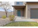 Inviting front entrance with a stylish door, well-maintained landscaping, and a charming walkway at 19060 E 54Th Pl, Denver, CO 80249