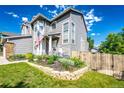 Beautifully landscaped front yard with stone edging and lush greenery at 1932 Sandhurst Dr, Castle Rock, CO 80104