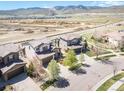 Aerial view showcasing a neighborhood, nearby mountains, and construction in the distance at 15194 W Washburn Ave, Lakewood, CO 80228