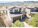 An aerial view of the property featuring a well-manicured front lawn, and a two-car garage at 15194 W Washburn Ave, Lakewood, CO 80228
