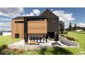 Contemporary home with a stone patio, outdoor fireplace, and large windows at 11168 Wild Chase Pl, Franktown, CO 80116