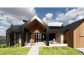 A contemporary home with a covered entryway, large windows, and wood and metal siding at 11168 Wild Chase Pl, Franktown, CO 80116