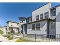 Well-maintained townhouse showcases modern design and landscaping and inviting walkway at 16057 E 47Th Pl, Denver, CO 80239