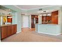 Modern kitchen features updated appliances, breakfast bar, and wooden cabinets at 8100 E Union Ave # 614, Denver, CO 80237