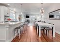 Open-concept living room with a fireplace, dining area, and modern kitchen at 1140 S Sherman St, Denver, CO 80210