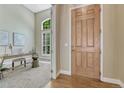 Inviting entryway featuring a wooden front door and an adjacent office space with a large window at 12344 Turquoise Terrace St, Castle Pines, CO 80108