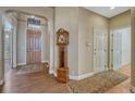 Inviting foyer features hardwood floors, a classic grandfather clock, and a view of the front entrance at 12344 Turquoise Terrace St, Castle Pines, CO 80108