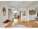 Bright foyer with hardwood floors that lead to the living room, showcasing open floor plan at 1011 S Valentia St # 30, Denver, CO 80247