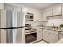 A kitchen showcasing stainless steel appliances, granite countertops, and light gray cabinets at 5120 Williams Fork Trl # 210, Boulder, CO 80301