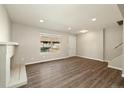 Well-lit living room with wood floors and a brick fireplace at 13003 W 20Th Ave, Golden, CO 80401