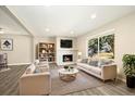 Comfortable living room featuring a fireplace, a couch, and two chairs at 13003 W 20Th Ave, Golden, CO 80401