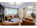 Spacious living room with leather seating, and view into dining area at 476 S Newport Way, Denver, CO 80224