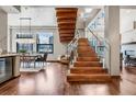 Modern, glass-railed staircase with rich wood finishes at 1800 Lawrence St # 505, Denver, CO 80202