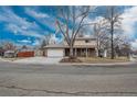 Suburban home featuring mature trees, attached garage and traditional design at 13778 W 71St Pl, Arvada, CO 80004