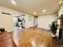 Open-concept living room featuring hardwood floors and seamless access to the modern kitchen at 2543 Westchester Dr, Denver, CO 80221