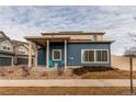 Two-story home with blue siding, a covered porch, and a well-maintained front yard at 19149 E 55Th Ave, Denver, CO 80249