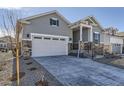 Gray two-story home with a two-car garage, covered entryway, and contemporary design at 8946 S Rome Ct, Aurora, CO 80016