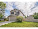 Charming home with a well-maintained lawn, fenced backyard, and a detached garage/shed at 4814 Kingbird Dr, Frederick, CO 80504