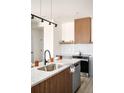 Bright kitchen featuring granite countertops, wooden accents, and stainless steel appliances at 9181 W Eaton St, Westminster, CO 80031