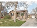 Exterior showcasing the front of the home, driveway, and a well-kept lawn and garden at 4180 S Elati St, Englewood, CO 80110