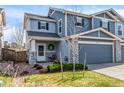 Attractive townhome with covered porch, stone accents, and well-manicured lawn at 6276 Turnstone Pl, Castle Rock, CO 80104