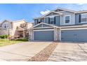 Inviting townhome with two-car garage and driveway, set amidst a well-kept lawn at 6276 Turnstone Pl, Castle Rock, CO 80104