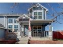 Covered front porch with brick steps and railing at 11673 Josephine St, Thornton, CO 80233