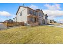 Two-story home featuring a two-car garage, with neutral exterior paint and an adjacent grass area at 567 Jewel St, Brighton, CO 80603