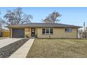 Ranch-style home with a brick facade, wood accents, and a well-maintained front yard at 51 S Eaton St, Lakewood, CO 80226