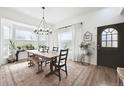 Bright dining room featuring a chandelier, large windows, and modern decor at 20765 E 39Th Ave, Denver, CO 80249