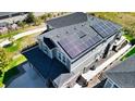 House with solar panels on the roof, backyard, and driveway at 26994 E Indore Ave, Aurora, CO 80016